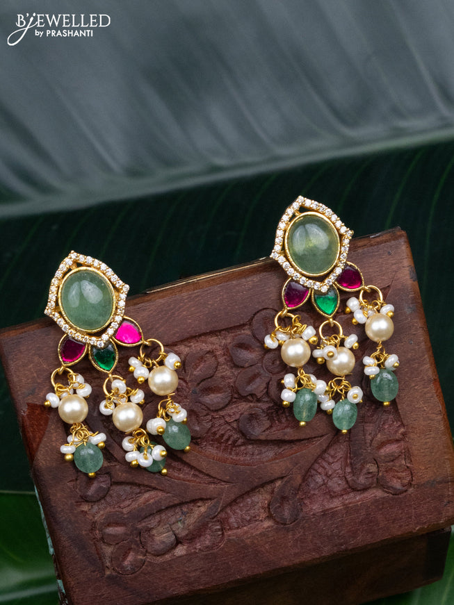 Jadau screw type earrings with jadau kundan stones and pearl & mint green beads hanging