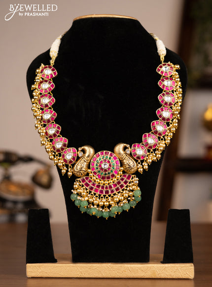 Antique necklace peacock design with jadau kundan stones and green & golden beads hanging without earring