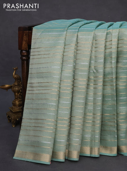 Tissue silk saree teal shade with allover silver & zari weaves and zari woven border