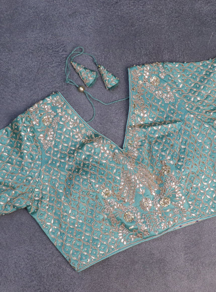 Tissue silk saree teal shade with allover silver & zari weaves and zari woven border