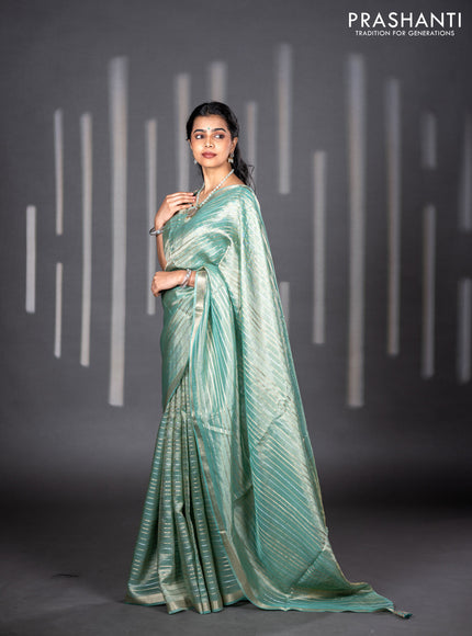 Tissue silk saree teal shade with allover silver & zari weaves and zari woven border