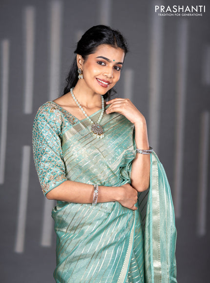 Tissue silk saree teal shade with allover silver & zari weaves and zari woven border