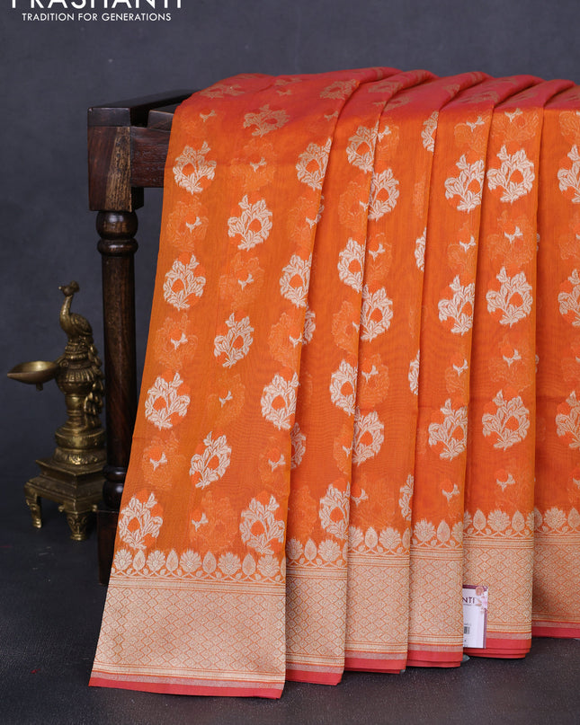 Banarasi silk cotton saree orange with allover floral zari woven buttas and zari woven border