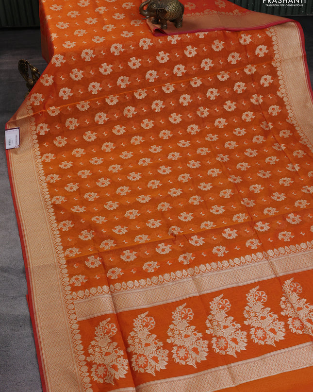Banarasi silk cotton saree orange with allover floral zari woven buttas and zari woven border