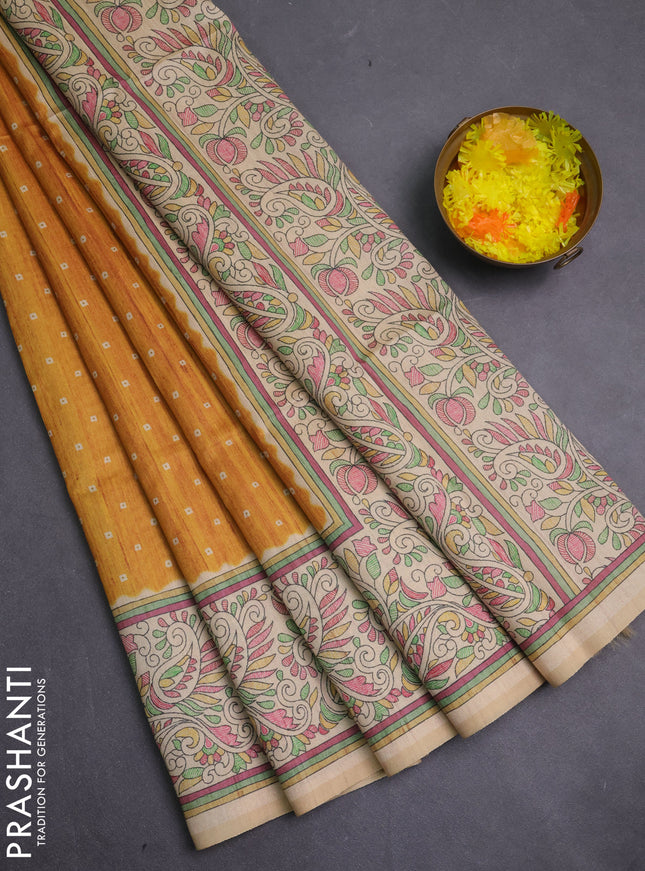Semi tussar saree mustard yellow and cream with allover bandhani prints and madhubani printed pallu & border