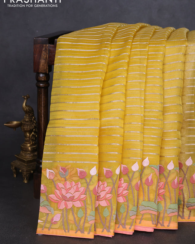 Pure organza silk saree yellow and peach shade with allover silver zari weaves and floral embroidery border