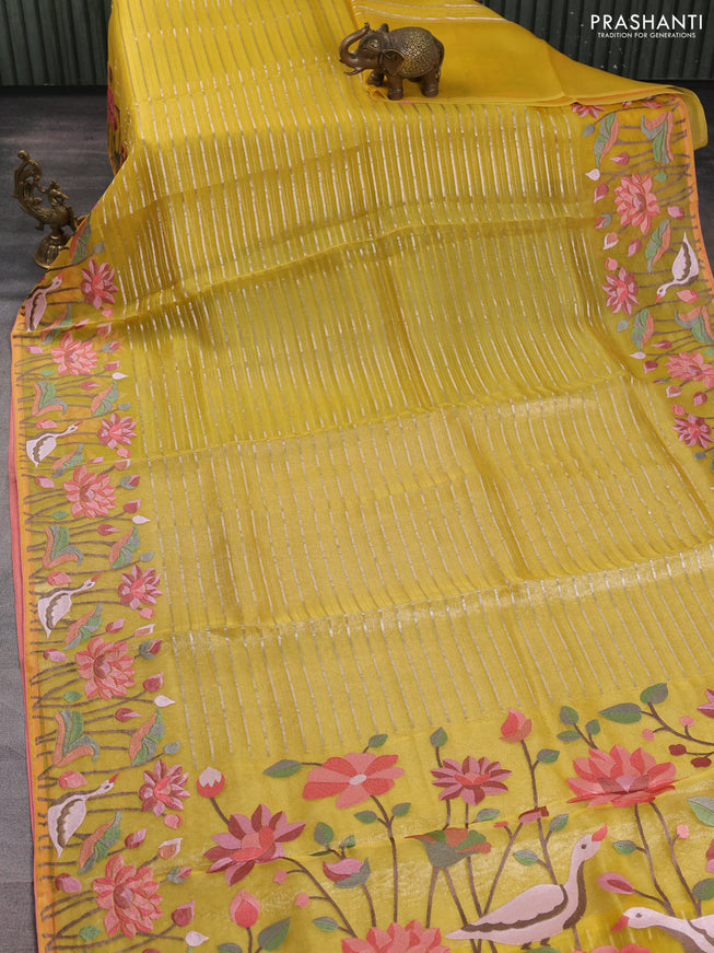 Pure organza silk saree yellow and peach shade with allover silver zari weaves and floral embroidery border