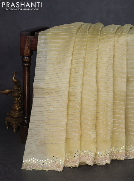 Pure organza silk saree pale yellow with allover zari weaves and sequin mirror work border