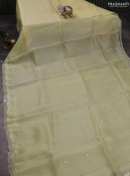 Pure organza silk saree pale yellow with allover zari weaves and sequin mirror work border