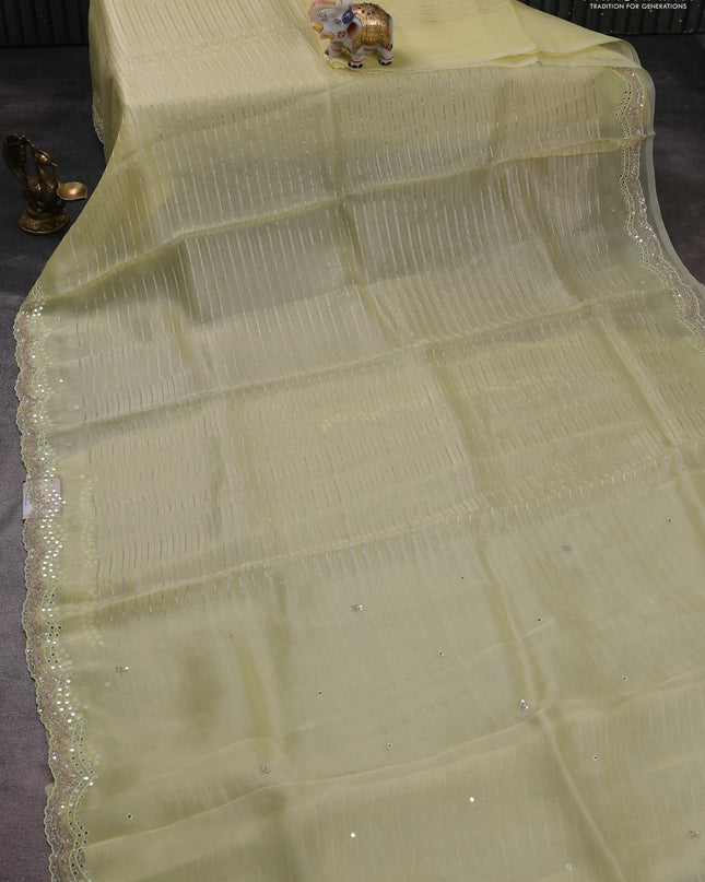 Pure organza silk saree pale yellow with allover zari weaves and sequin mirror work border