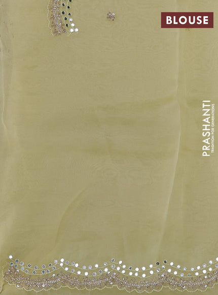 Pure organza silk saree pale yellow with allover zari weaves and sequin mirror work border