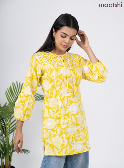 Cotton short kurti yellow and off white with allover prints & simple neck pattern without pant