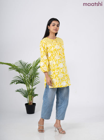 Cotton short kurti yellow and off white with allover prints & simple neck pattern without pant