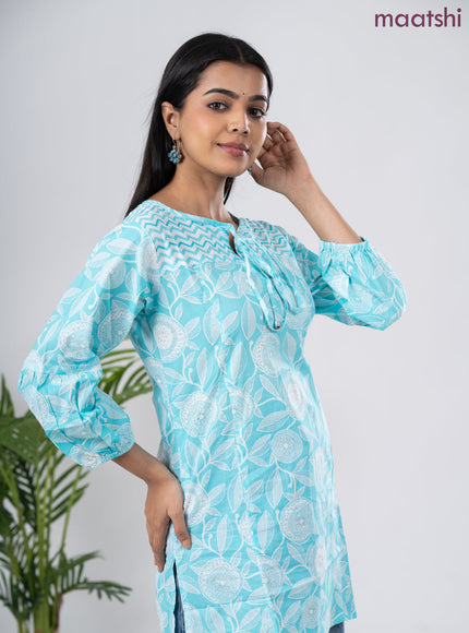 Cotton short kurti light blue and off white with allover prints & simple neck pattern without pant