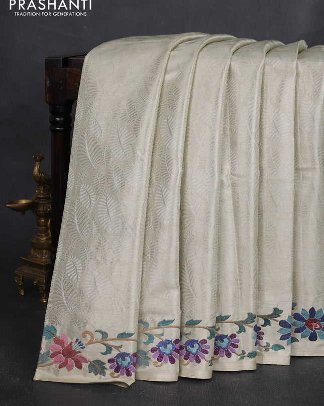 Tissue silk sare off white and pink rust shade with allover brocade weaves and embroidery work border