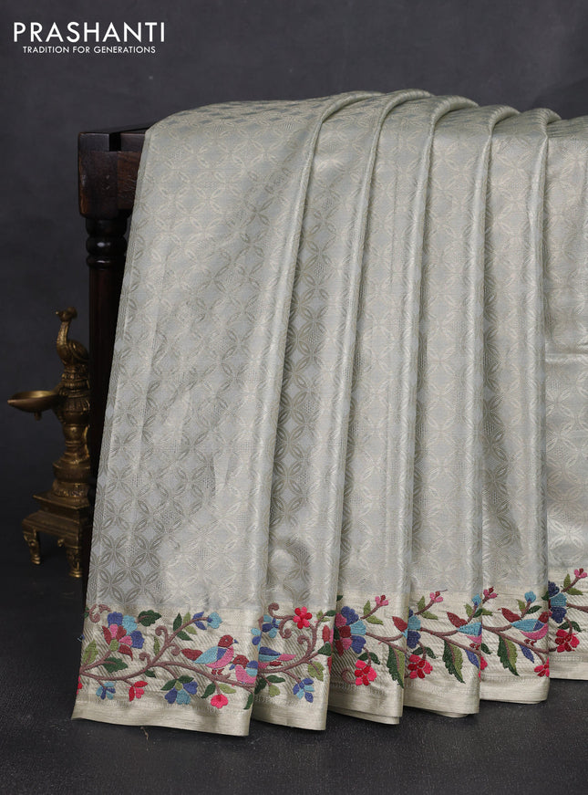 Tissue silk sare pastel grey with allover brocade weaves and embroidery work border
