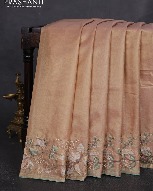 Tissue silk sare golden peach and pastel green with plain body and embroidery work border