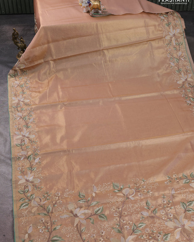 Tissue silk sare golden peach and pastel green with plain body and embroidery work border
