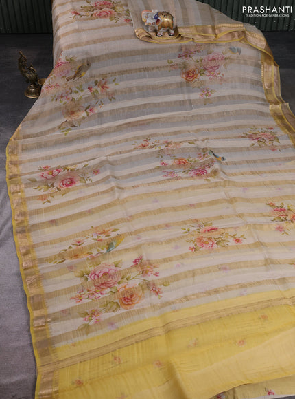 Organza tissue tussar silk saree cream shade with allover zari stripe pattern & floral prints and zari woven border