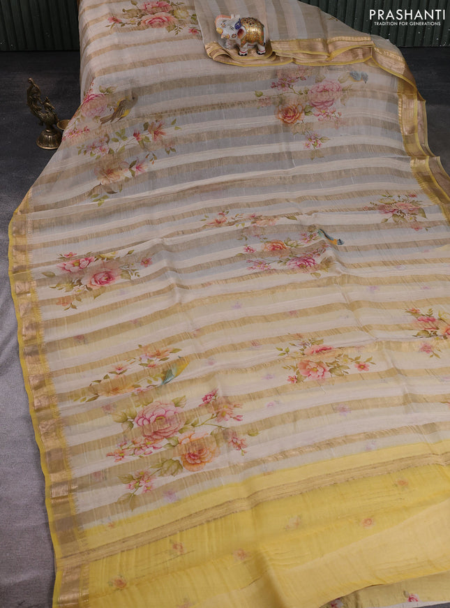 Organza tissue tussar silk saree cream shade with allover zari stripe pattern & floral prints and zari woven border