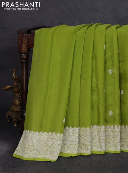 Banarasi chiffon saree lime green with allover silver zari woven buttas and silver zari woven floral border