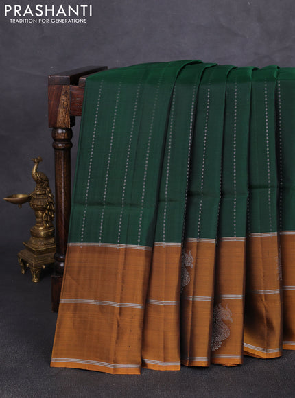 Kanchipuram soft silk saree bottle green and mustard yellow with allover silver zari weaves and long zari woven butta border