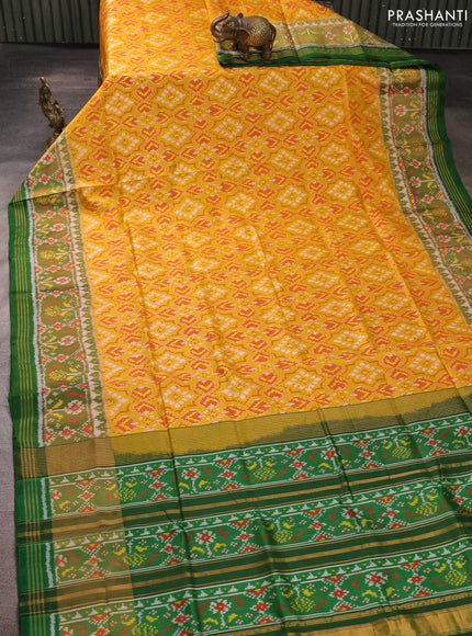 Rajkot patola silk saree mustard yellow and green with allover ikat weaves and ikat woven zari border