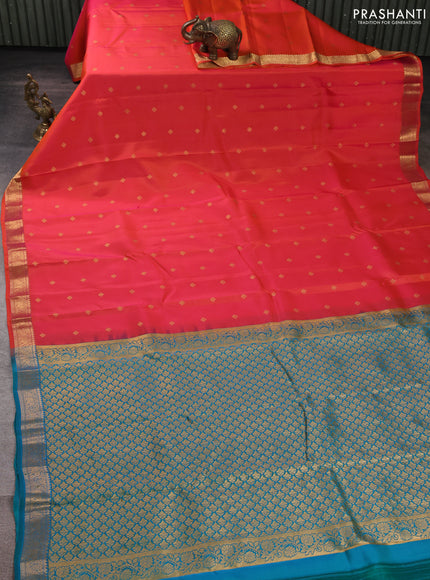 Kanchipuram silk saree dual shade of pinkish orange and teal green with allover zari woven buttas and zari woven border