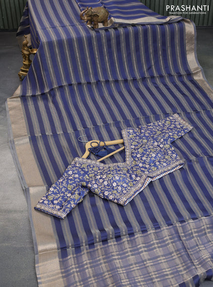 Organza saree blue with allover zari weaves and zari woven border