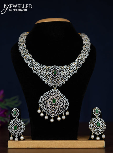 Zircon necklace with emerald & cz stones and pearl hangings in gold finish