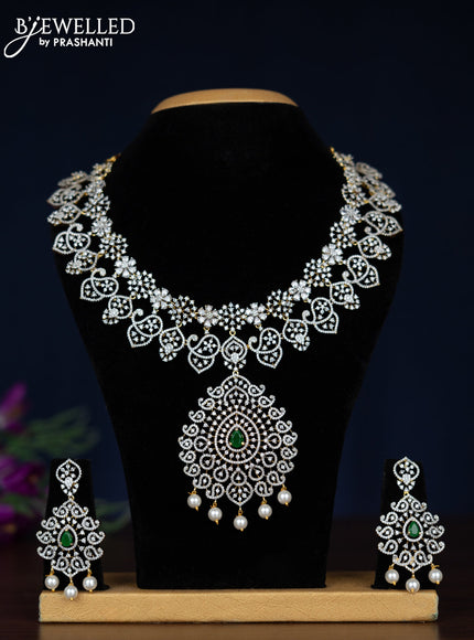 Zircon necklace with emerald & cz stones and pearl hangings in gold finish