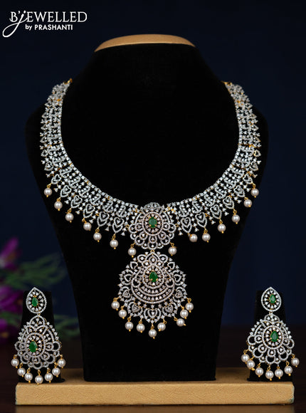 Zircon necklace with emerald & cz stones and pearl hangings in gold finish
