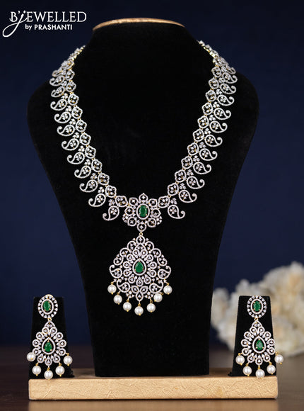 Zircon haaram manga pattern with emerald & cz stones and pearl hangings in gold finish