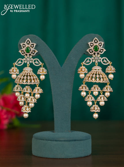 Zircon jhumkas with emerald & cz stones and pearl hangings in gold finish