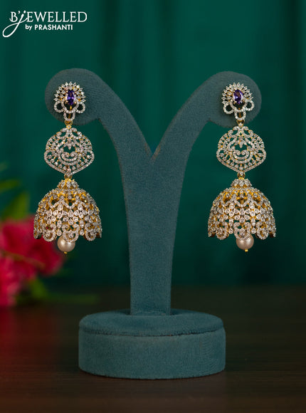 Zircon jhumkas with purple & cz stones and pearl hanging in gold finish
