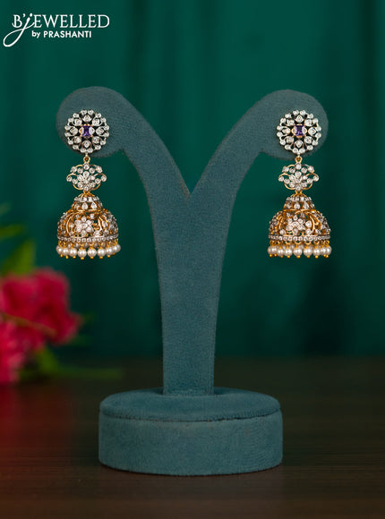 Zircon jhumkas with purple & cz stones and pearl hanging in gold finish
