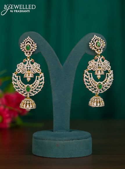 Zircon jhumkas peacock design with emerald & cz stones and pearl hanging in gold finish