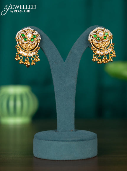 Antiuqe earrings with green jadau kundan stones and golden beads hangings