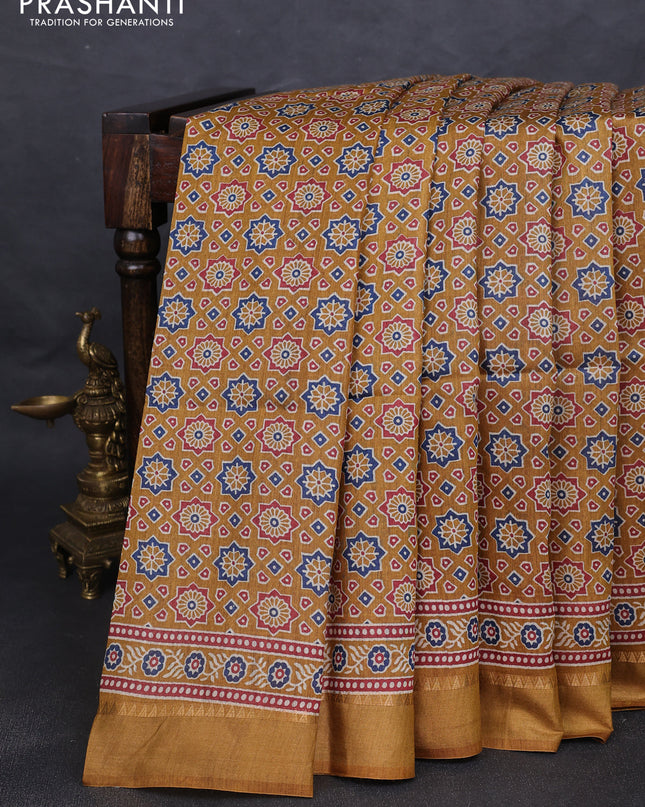 Munga tussar silk saree dark mustard with allover ajrakh prints and zari woven border