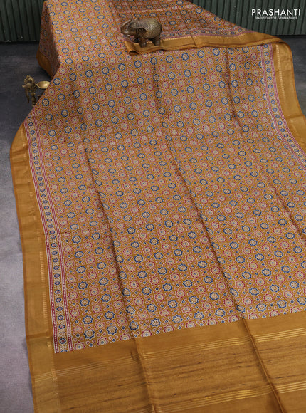 Munga tussar silk saree dark mustard with allover ajrakh prints and zari woven border