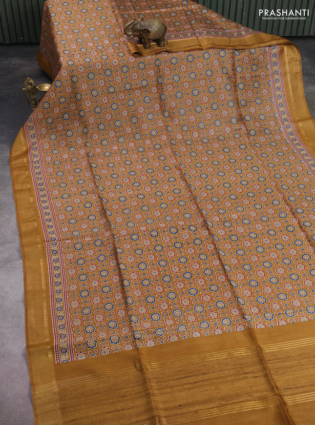 Munga tussar silk saree dark mustard with allover ajrakh prints and zari woven border