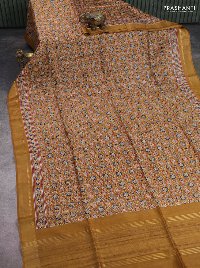 Munga tussar silk saree dark mustard with allover ajrakh prints and zari woven border