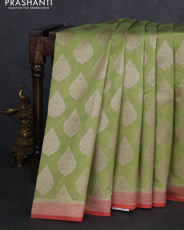 Banarasi silk cotton saree light green and peach pink with allover zari woven buttas and zari woven border