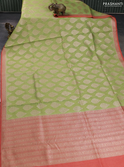 Banarasi silk cotton saree light green and peach pink with allover zari woven buttas and zari woven border