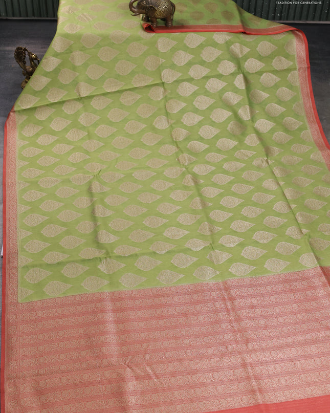 Banarasi silk cotton saree light green and peach pink with allover zari woven buttas and zari woven border