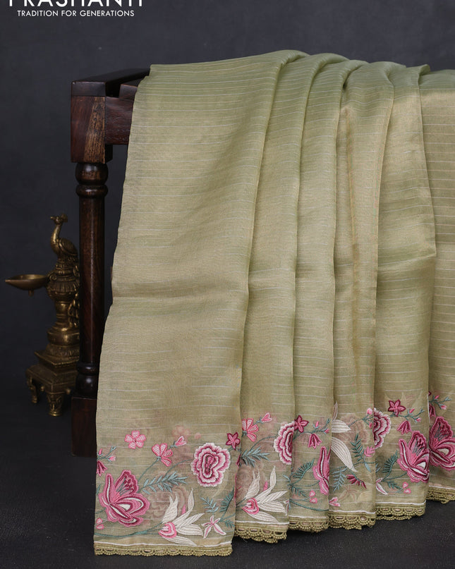 Tissue silk saree elachi green with allover zari weaves and kutch embroidery border