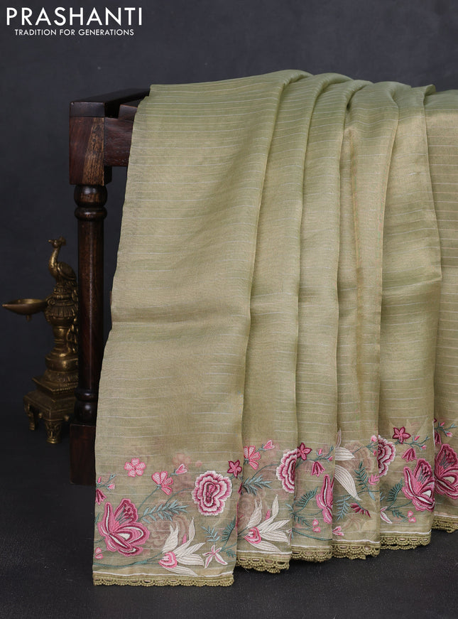 Tissue silk saree elachi green with allover zari weaves and kutch embroidery border