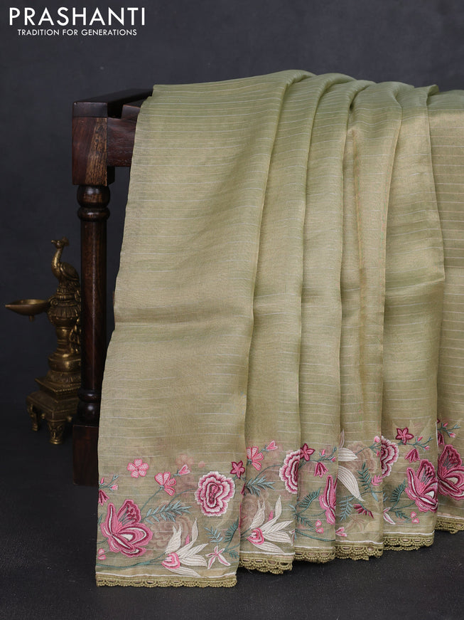 Tissue silk saree elachi green with allover zari weaves and kutch embroidery border