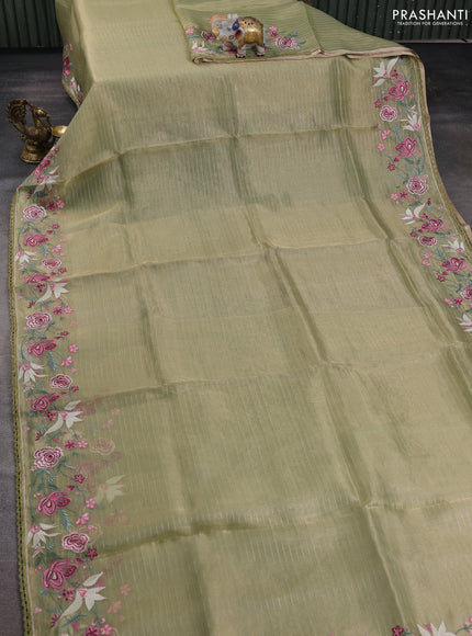 Tissue silk saree elachi green with allover zari weaves and kutch embroidery border