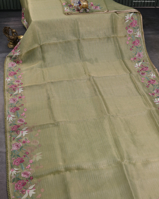 Tissue silk saree elachi green with allover zari weaves and kutch embroidery border